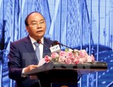 PM urges Hanoi to remove barriers for stronger development
