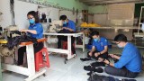 Youth union members sew masks for the public